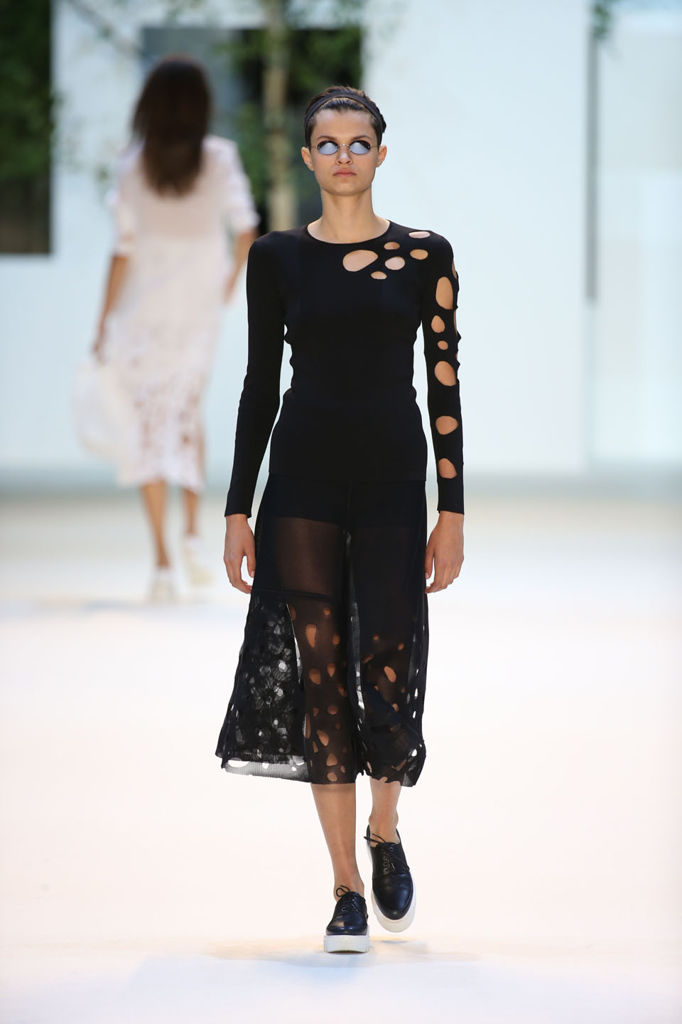 Isabella Emmack (Viva) Black knit pullover, techno mesh A-line skirt