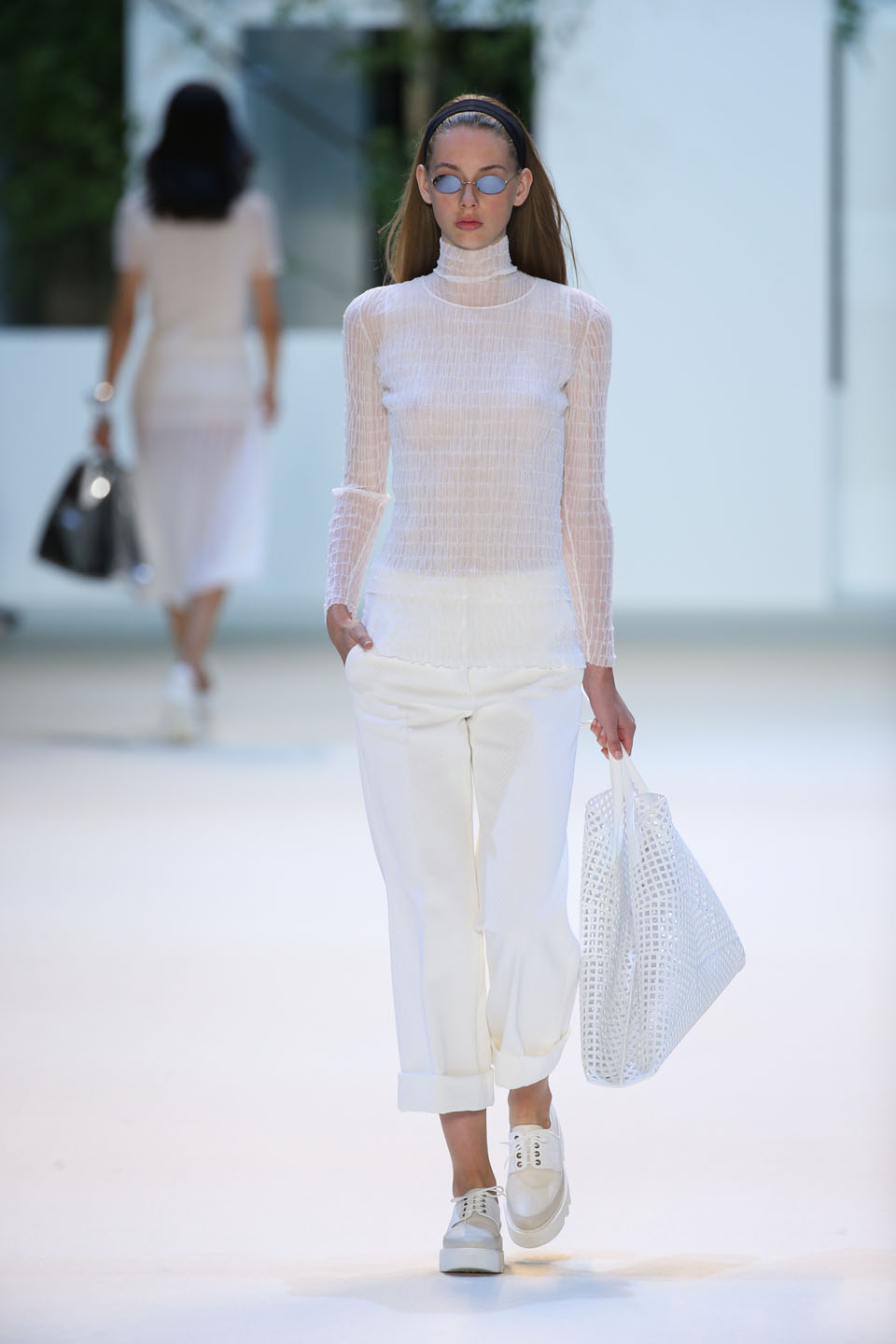 Lauren de Graaf (Elite) Pure white cotton knit top, pullover and wide leg gabardine cropped pants Large shoulder Ai in lasercut leather